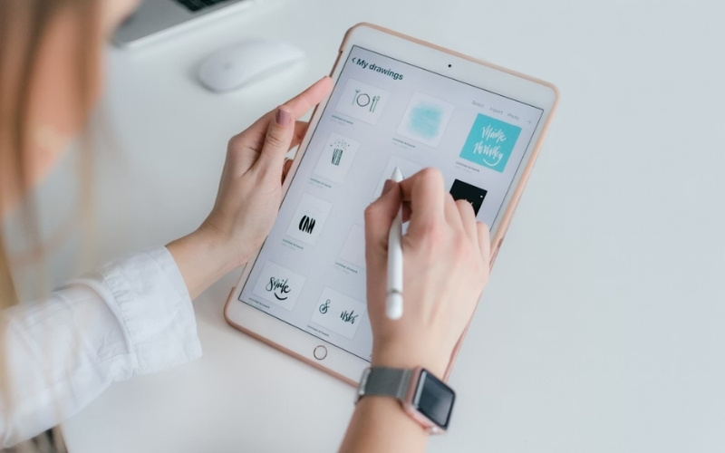 Student using free ipad from lifeline program for creative work or school tasks